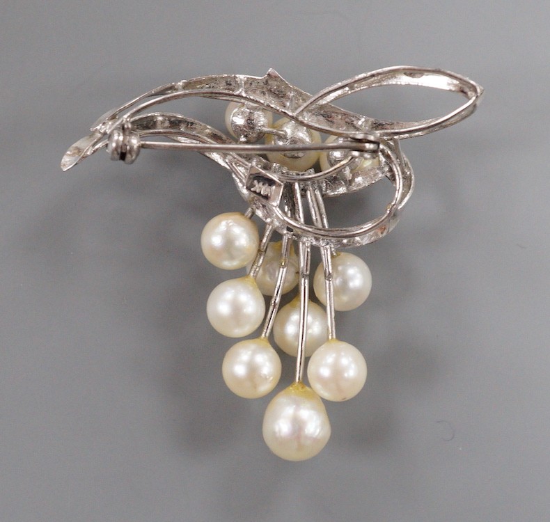 A modern 14k and graduated eleven stone cultured pearl cluster set brooch, 40mm, gross weight 7.4 grams.
